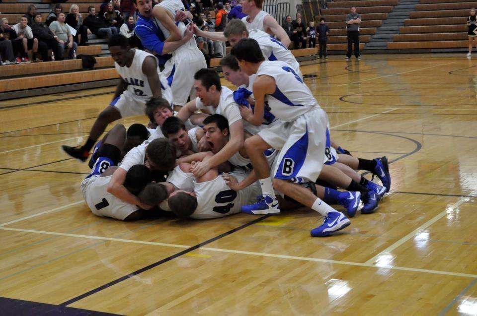 The team piles on top of John Veil 14, who scored an amazing winning shot. 