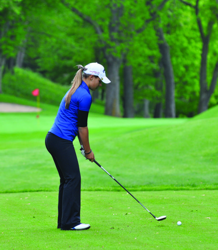 Lilia plays golf  at the Blake Girls Section meet.