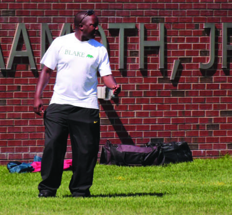 Coach Tamba John directs  his players from the sidelines of Aamoth Stadium.
