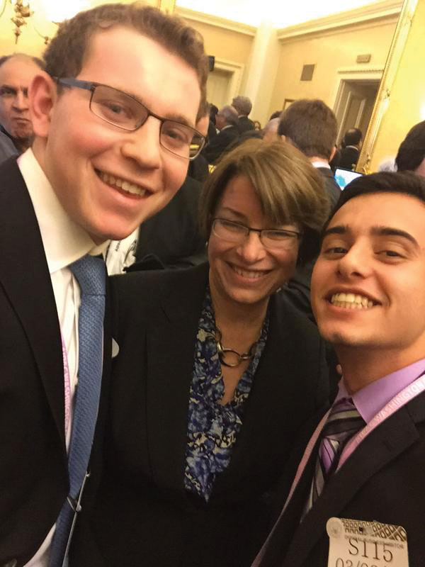 A junior and his friend AJ Yablonski take a picture with Minnesota Senator Amy Klobuchar