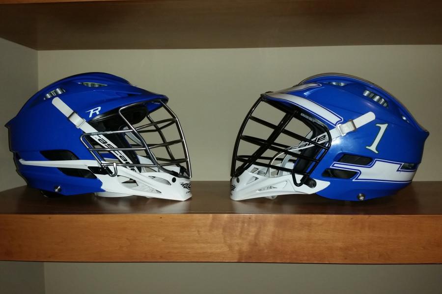 Two Blake lacrosse helmets. A new Cascade R helmet on the left and an old Cascade CPX-R helmet on the right.