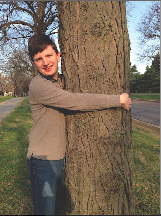 Brendan Barrow, devoted treehugger, on the schools front lawn