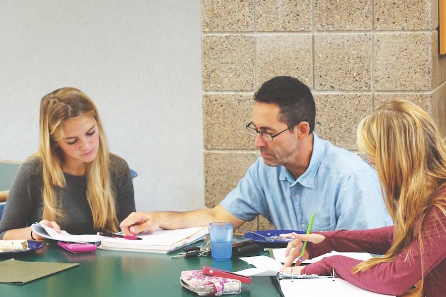 Code switching, defined as the practice of using different varieties of language in conversation, is usually brought out when talking to teachers. Callie Abraham 17, Savannah Swanson 17 and Steve Kaback converse about Physics during lunch. 