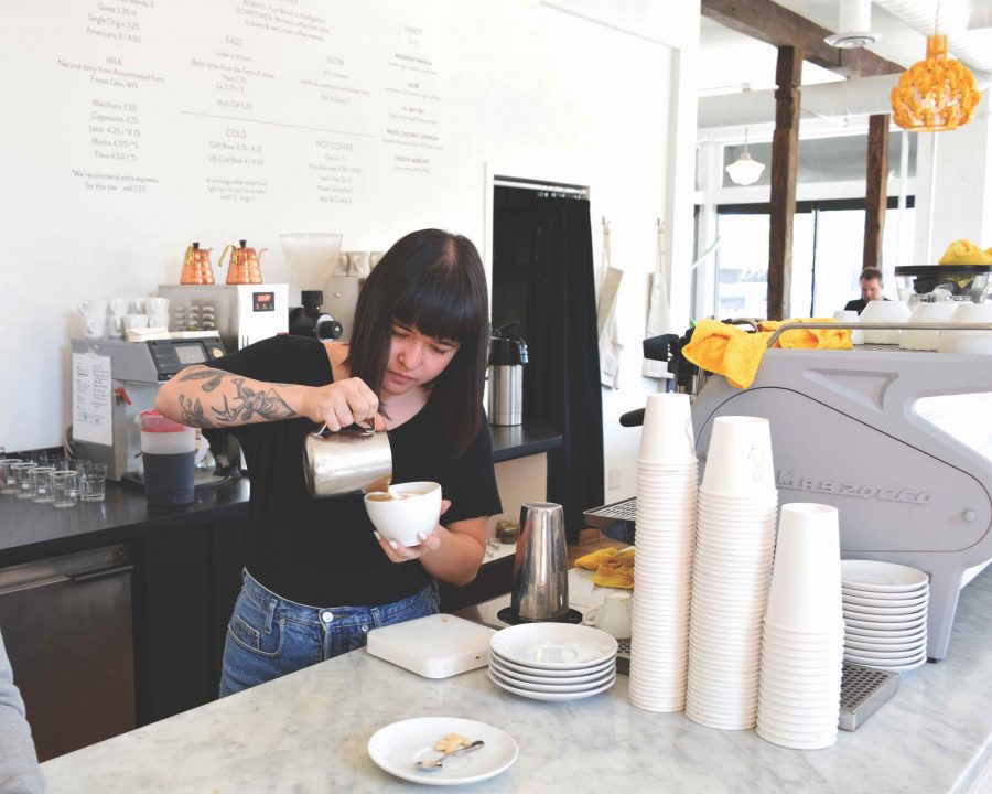 Rachel, a barista at Urban Bean coffee, utilizes her foam technique when pouring a latte. 