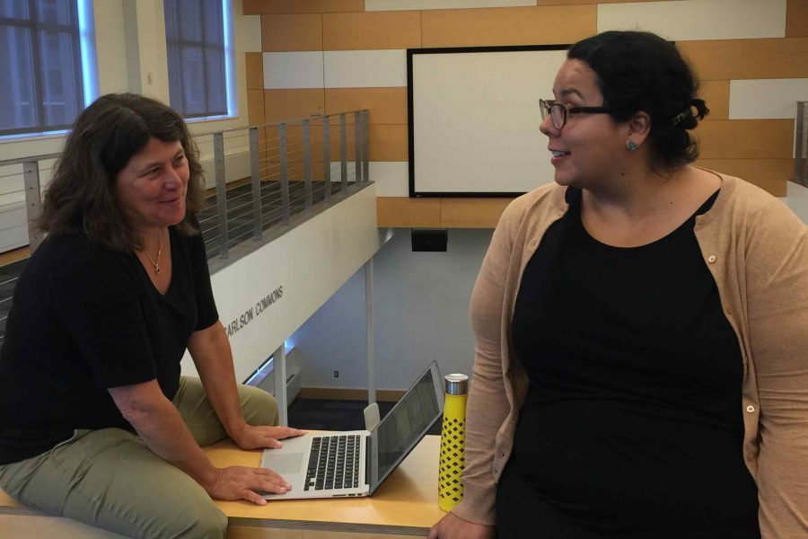 Karen Phillips and Ann Rubin discuss schedules in the library