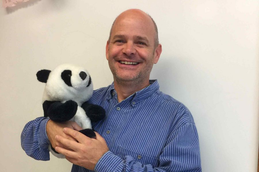 Jon Dicus holds Canvas, a panda bear used in class to show students how friendly the program can be.