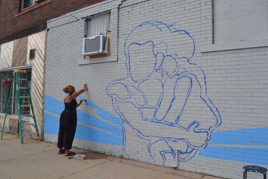 Cameron Downey in the beginning stages of making the mural. 