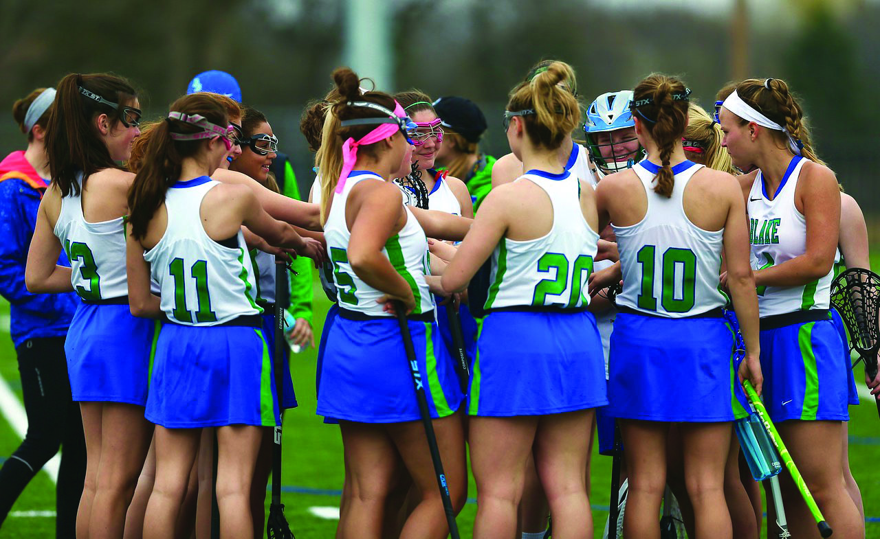 The Girls lacrosse team huddles up before a game.