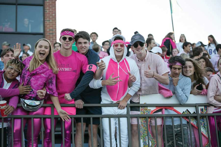 From left to right: Thomas Washington 18, Sara McClanahan 18, Bjorn Holm 18, Kyle Meredith 18, Jackson Saunders 18, Bennett Hawley 18, Sam Shapiro 18, and Emily Hykes 18 lead cheers at the Play for Pink Wolfpack game against St. Croix Lutheran.