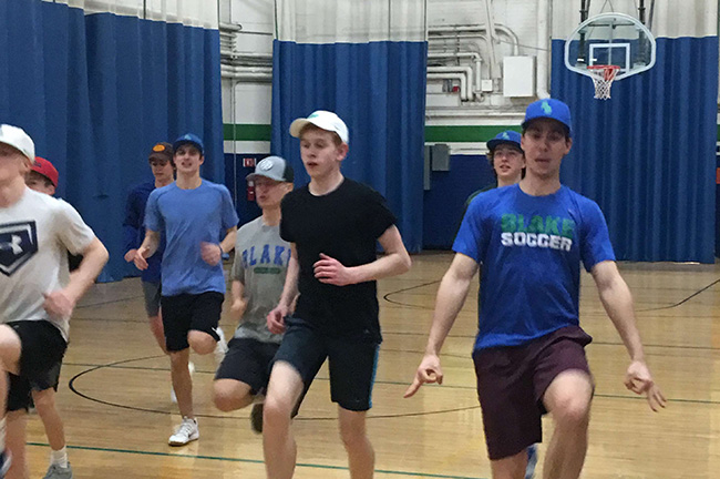 The team warms up in the gym before a practice