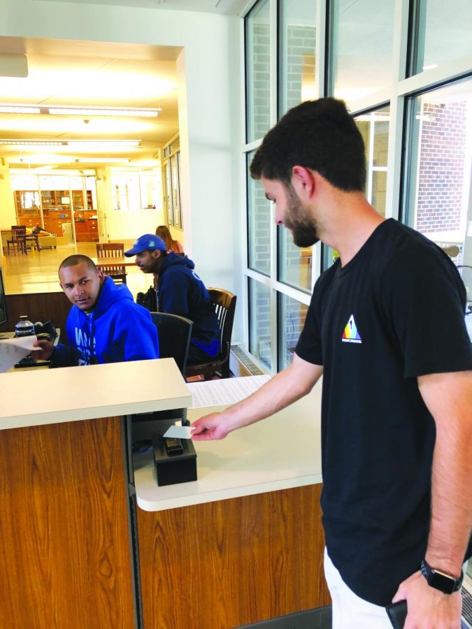 Cole Mathews swipes his card at the west door. This year, Brandon Krona (pictured above) and the rest of the security team have made swiping out mandatory when leaving the campus during school ours