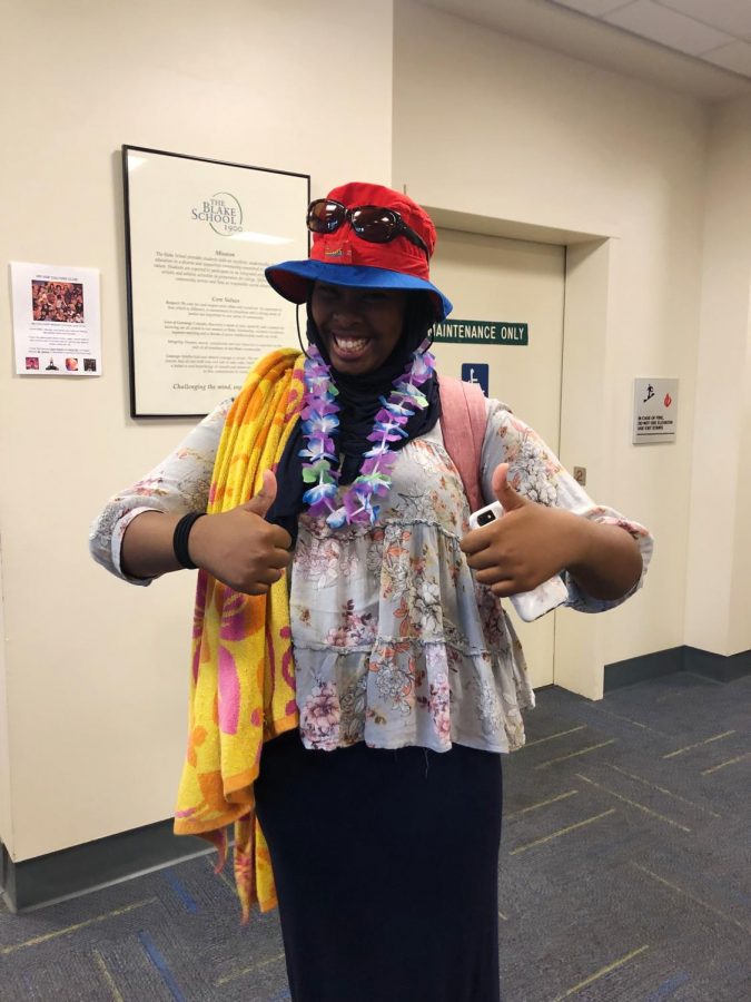 Habon Samatar 22 is beach ready with a pair of sunnies, a lei, a towel, and a bucket hat