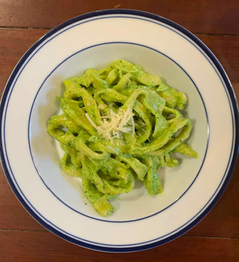 The finished cut and cooked pasta mixed with pesto.