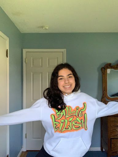 Laila Elbakkal 21 is sporting her Billie Eilish sweatshirt. Wearing an expressive sweatshirt or top is a great way to have fun with fashion on Zoom.