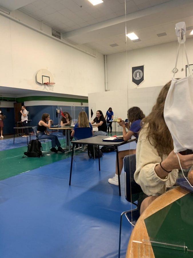 Tables of four students now separate each person by a plexiglass structure. This ensures that students are safe when eating, as their masks are off during this period of time. Students are required to wear their masks at all other times of the day. There are also individual desks in the lunch room, also six feet apart from any other table or desk. 