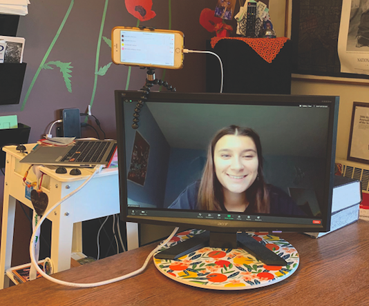 Anna Reid’s set up in her classroom consists of three devices: her computer, her phone, and a monitor that all display different parts of the Zoom.