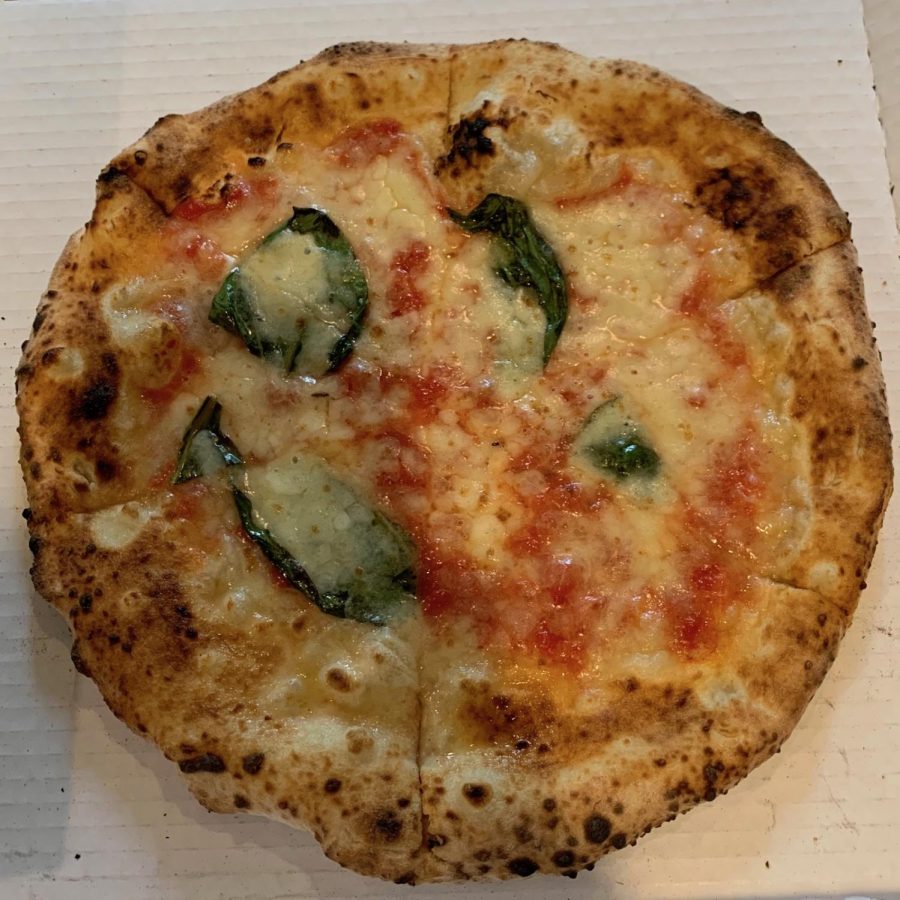Punchs classic Margherita pizza with basil.