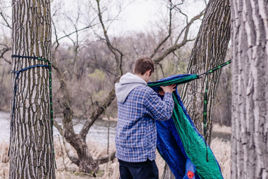Frederick Loew ‘22 hangs an ENO Hammock at Hidden Beach Park near Lake of the Isles. Even in colder weather, mocking can be fun if you bring blankets and warm clothes. It’s also possible to hang hammocks above  one another to create a “stack” of sorts. Although slightly dangerous, it is helpful if you are in a location that isn’t densley forested. 