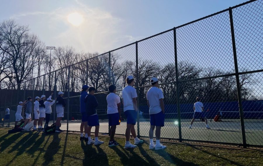 The+team+lost+to+Orono+1-6+at+their+match+on+Thursday+Apr.+21%2C+2022.+The+match+was+at+Blake+on+one+of+the+first+sunny+days+in+April.+Pictured%3A+Varsity+players+cheering+on+their+fellow+teammates%2C+while+waiting+for+their+matches+to+start.++