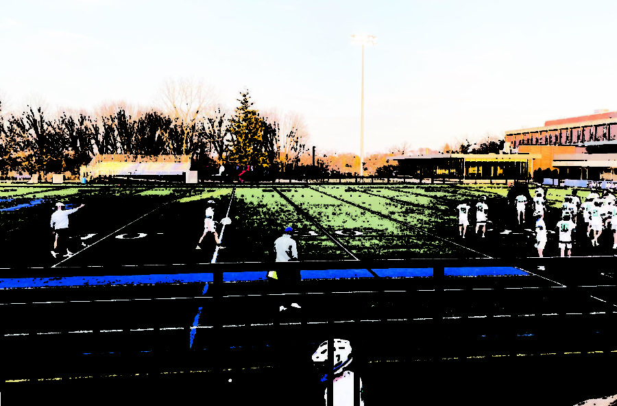 Student athletes practice while it is still light outside.