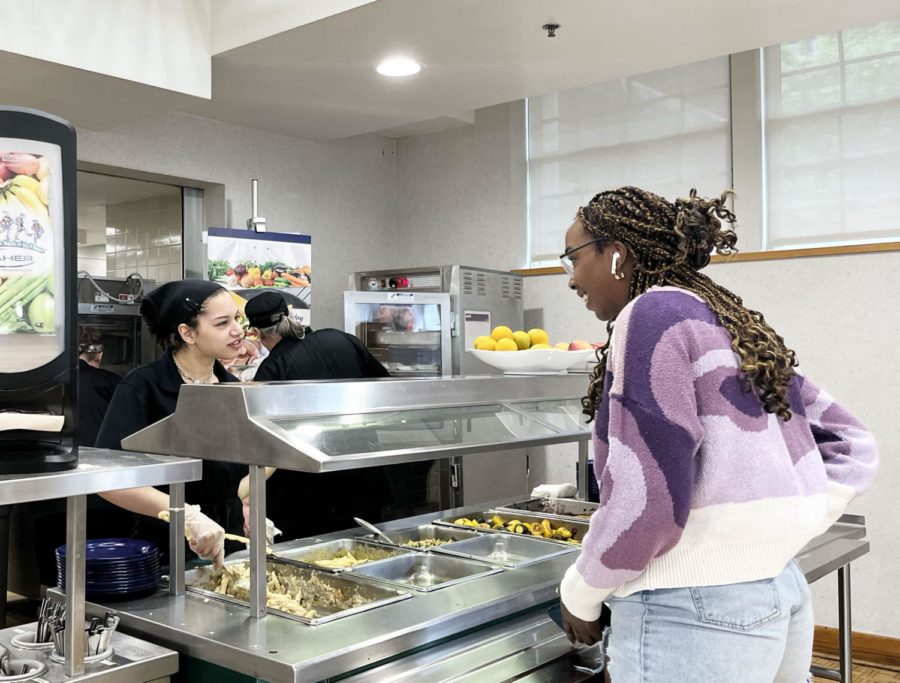 Nicholson serves students and teachers everyday, typically at the counter near the sandwich station. Here, she serves and talks with Precious Jones ‘22 during first lunch.