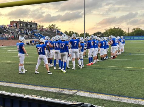 The Wolfpack prepare for their epic Friday night matchup against DeLaSalle. As the starting lineup is announced, the team readies itself for any challenges that present themselves. The Wolfpack ended up winning this game with a whopping score of 44-0.