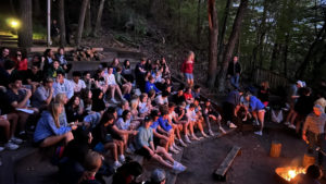 Class of 2023 sings “Sweet Caroline” and “Wonderwall” around the fire pit to end their retreat in Wisconsin.