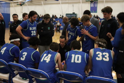 Boys Varsity Basketball gathers together before a game to motivate each other, showing a connection that stretches beyond the game.