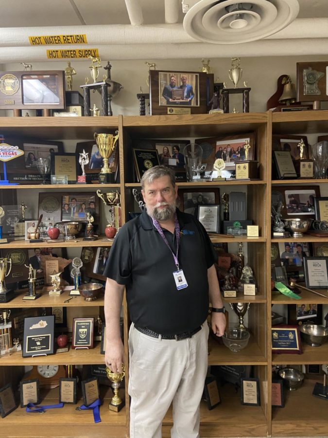 Stafford stands in front of the debate team’s extensive trophy
case. Not pictured: the rest of the trophies that sit outside of the
debate room. Terveen notes, “[There is] definitely no [pressure to
win]. Although he is of course very proud when teams do well!”