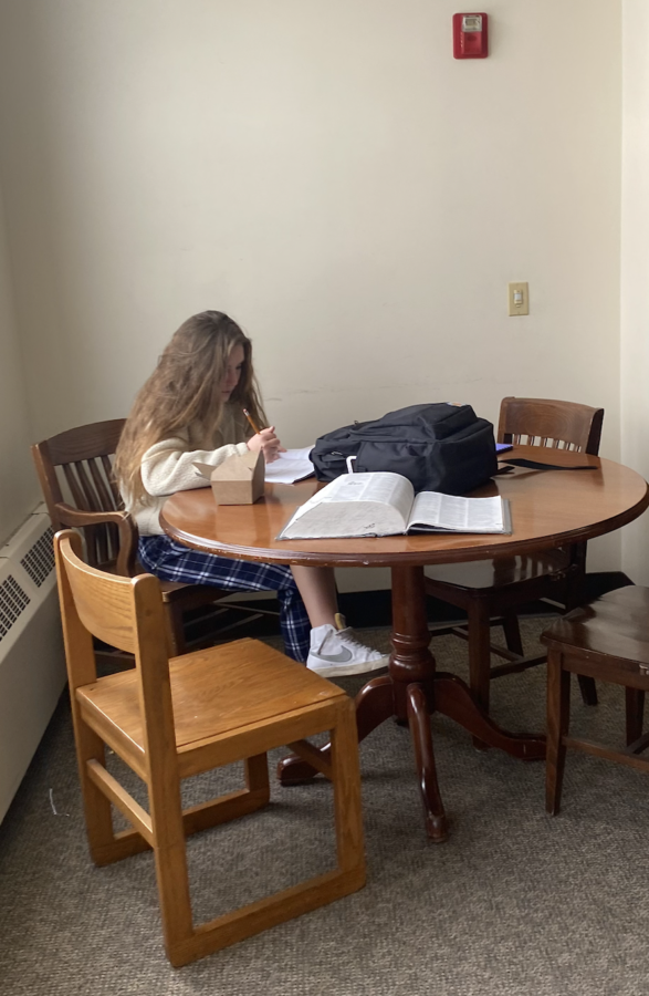 Eloise Walsh ‘24 focused on reading homework in the OECE wing on the third floor.