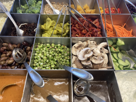 The salad bar is filled with delicious toppings to build your salad.