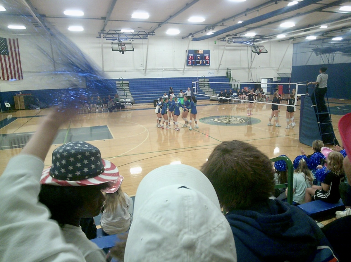 Players celebrate in a huddle after winning a thrilling rally. 