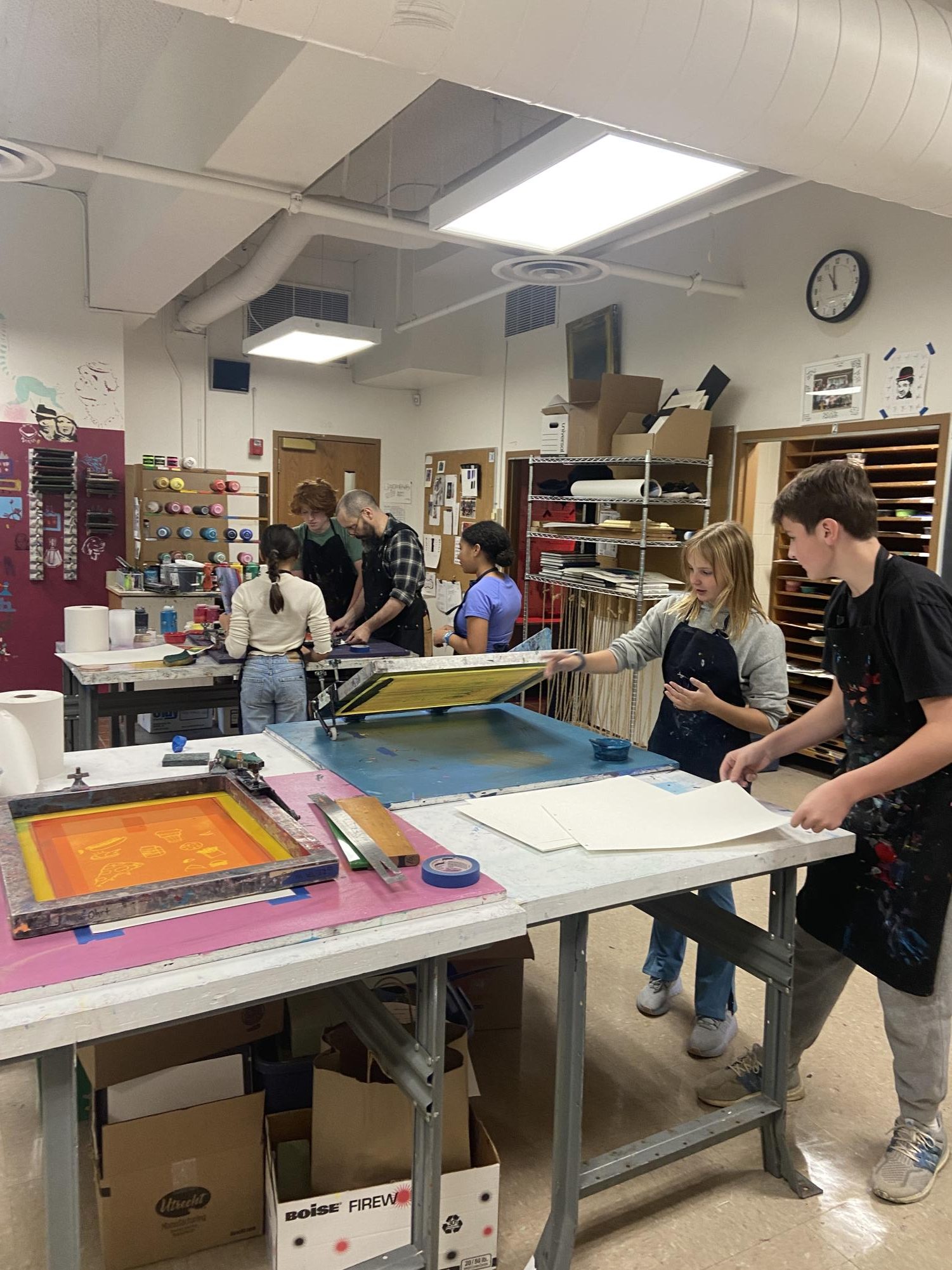 Students in Sago’s printmaking class work together and learn from Fisher to create original pieces of art.