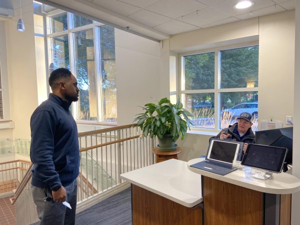 As students file through the East Entrance in the morning on Tuesday, Oct. 17, Bekele (left) and Hanson (right) discuss their plan and tasks for the day. 