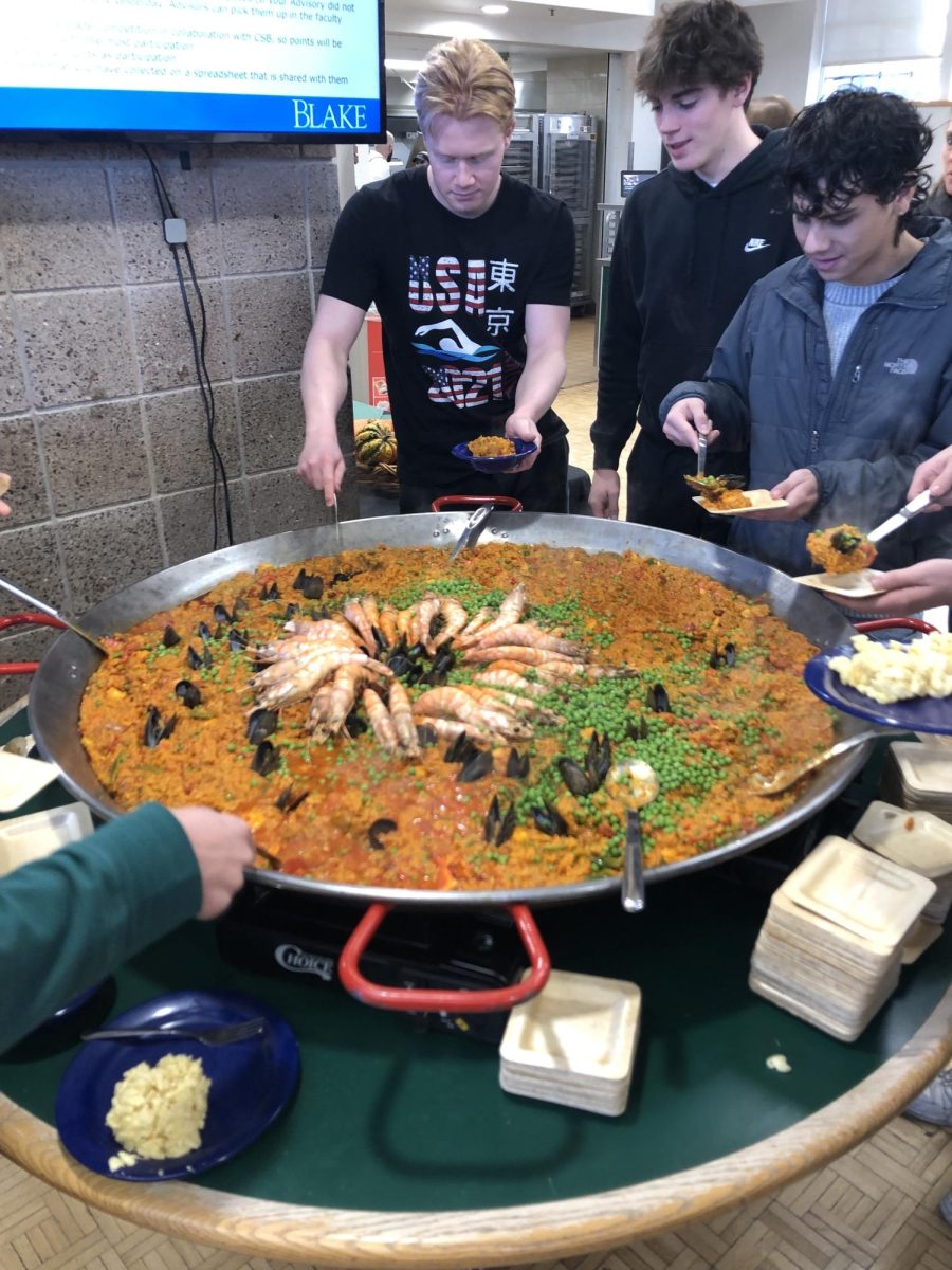 Dominic Bollettieri ‘25, Drew Dillon ‘25, and Miguel Quintero ‘25 serve themselves Chef Taher’s paella on Nov. 29.