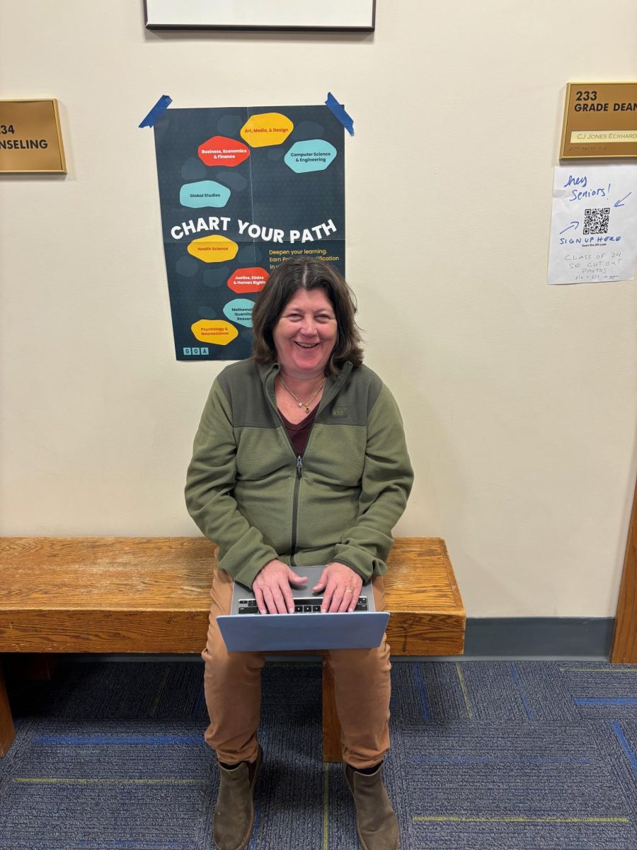 Phillips, enthusiastically working on her laptop, prepares for a meeting with Senior Class Dean CJ Eckhardt.