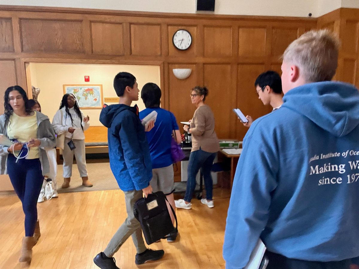 Wendy Johnson checks Alex Zhang ‘25, Eddie Shen ‘25, Tony Liu ‘25, and Roland Bentley ‘25 in for the PSAT on Oct. 18, 2023. The PSAT is the first standardized test students take.