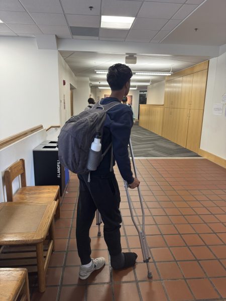 After fracturing his Tibia in a hard challenge against Minnehaha Academy, Vezmar walks the school's halls in crutches.