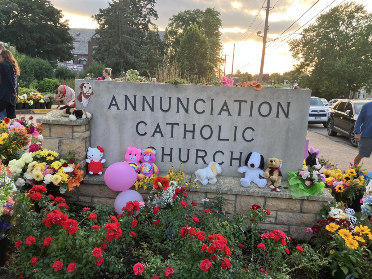 Just over 24 hours after, neighbors and people from everywhere grieved with the school by placing flowers, balloons, and stuffed animals on the Annunciation sign.