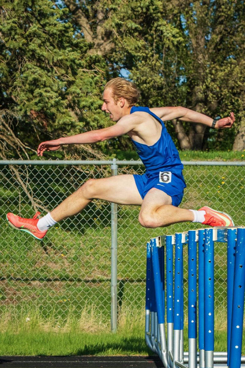 Bredesen jumps over a hurdle during a 300 meter race in an IMAC relay meet. The event took place on May 7 at Chub Bettels track.