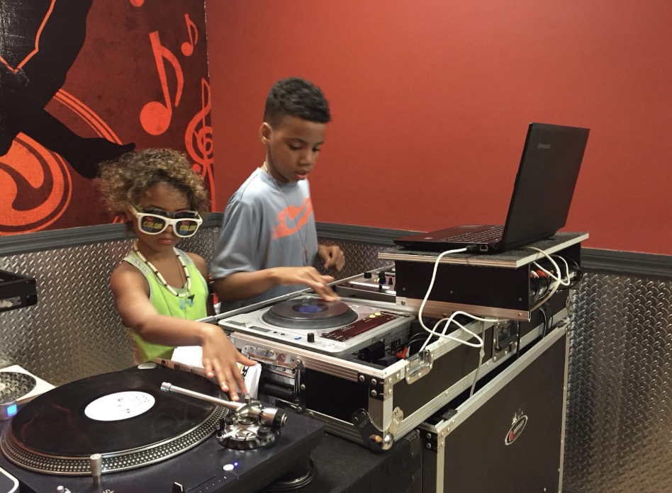 A young Bowles (left) practicing her DJing skills.
