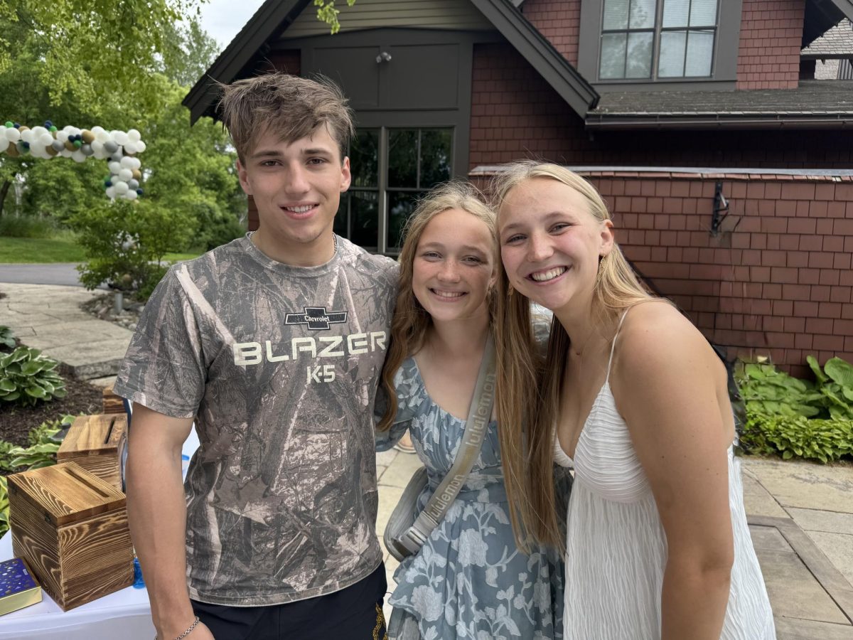 William Palmby ‘24, Palmby, and Charlotte Palmby ‘25 smile for a photo at Charlotte’s graduation party.