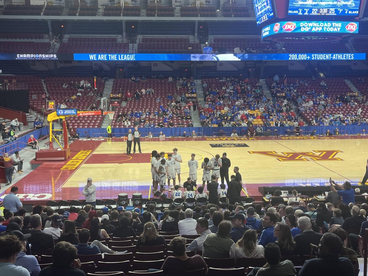 Coach Biwan (center) led the team to an unprecedented state run. The semifinal took place at Williams Arena. During this timeout on March 25, the Bears led Pequot Lake 25-22.