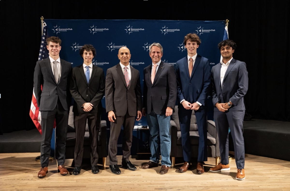 BEAM leaders Madhav Kumar '27 and Posada, along with members Cole Eckes '26 and Connor Briand '27, stand with Ecolab CEO Cristophe Beck (middle right) and Federal Reserve Bank of Minneapolis president and CEO Neel Kashkari (middle left) at an Economic Club of Minnesota luncheon on May 17, 2025.