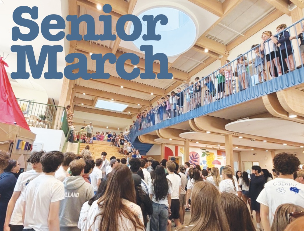 ELC students, faculty, staff, and seniors gather in the ELC as the seniors wait to ride on the slide. 
